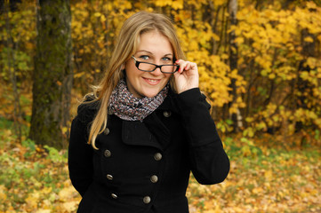Pretty blonde woman in autumn park