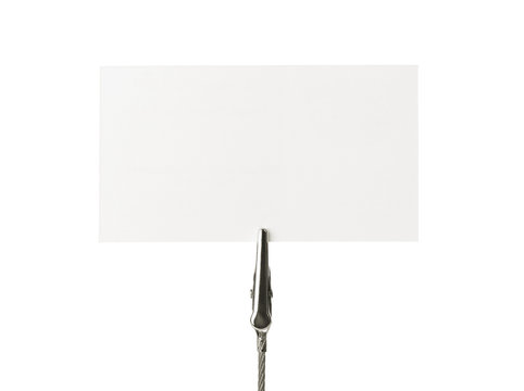 Blank business card on a clip over white background