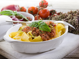 pappardelle bolognese with ragout sauce and basil leaf