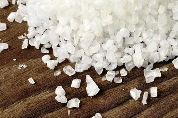 Coarse sea salt on a wooden table