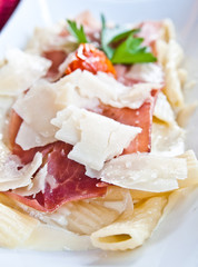 tasty pasta with roast ham on the table