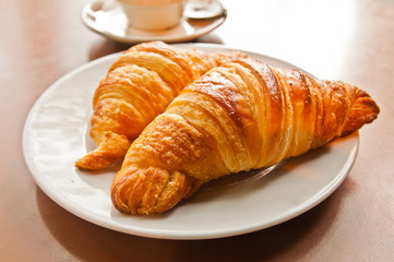 Breakfast with coffee and croissants