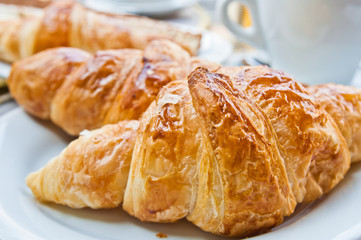 Breakfast with coffee and croissants