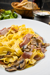 tasty pasta with roast ham on the table