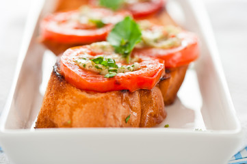 Bruschetta - gold baked baguette with tomato garlic and basil as