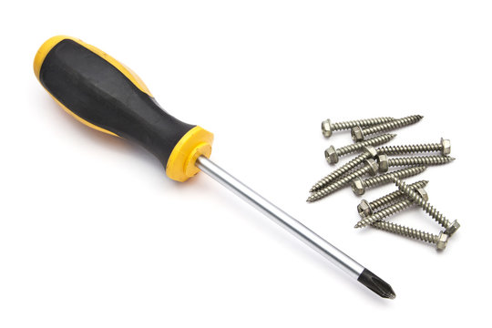 Yellow screwdriver and screws on white background