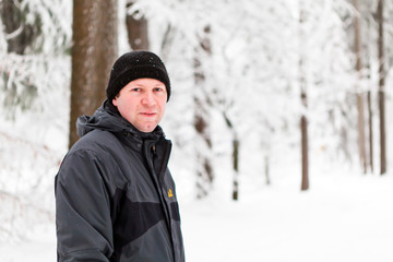 Fototapeta na wymiar lovely portrait of a young man in winter landscape