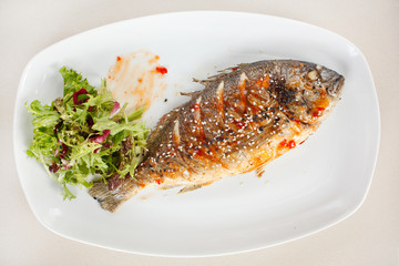 fried fish with fresh herbs and lemon