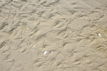 background with waves of sand and crystal water