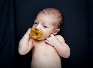 portrait of adorable newborn baby girl on black background © Tommaso Lizzul