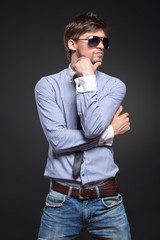 Obraz premium Fashion handsome man posing over black background
