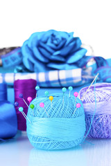 bright blue yarn, fabric, satin ribbon and measuring tape