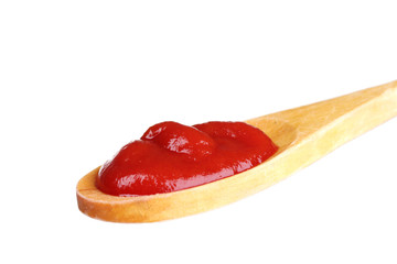 Tasty ketchup in wooden spoon isolated on white