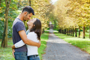 Fototapeta premium Young Couple Walking in autumn park