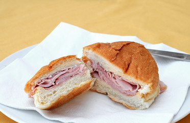 Soft bread roll with ham on a plate