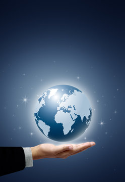 Earth globe in businessman hand on star and blue background