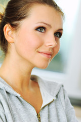 Beautiful young  woman looking away in thoughts