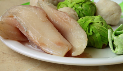 Fishes, meat balls and green noodles