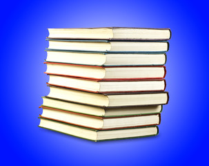 a stack of old books in the blue, isolated