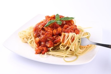 ghetti bolognese on a plate being eaten with a fork