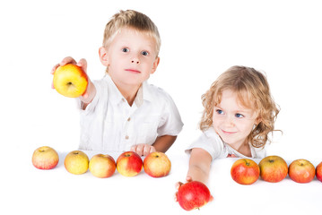 Fototapeta na wymiar Two kids offering apples isolated on white background