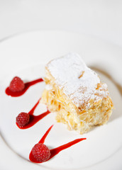 Piece of mille-feuille cake on porcelain plate