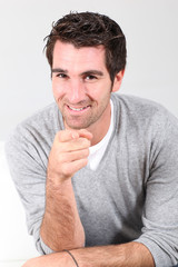 Portrait of handsome man pointing at camera