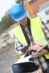 Construction manager using electronic tablet on site