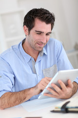 Office worker using electronic tablet