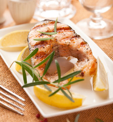 Grilled salmon steak with lemons and rosemary