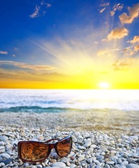 sunglasses  on a sea coast at the morning