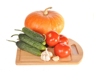 Vegetables on a board and a pumpkin