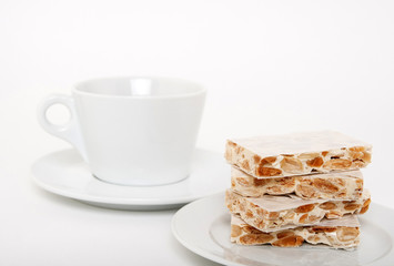 Turron, traditional Spanish dessert and a teacup