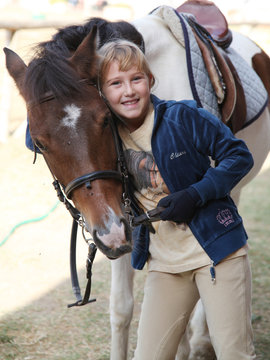 bambina  abbraccia cavallo