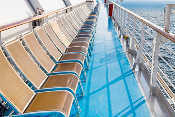 Fototapeta premium sunbath chairs on side of cruise liner