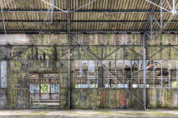 Fototapeta premium Derelict interior of dilapidated warehouse