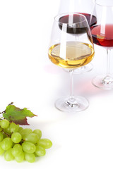 Glasses of white, red and rose wine and grapes