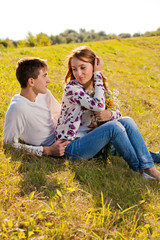 Fototapeta premium Love and affection between a young couple at the park in autumn