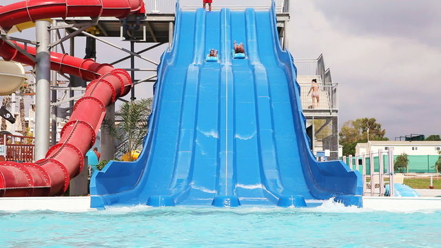 Sliding down on water slide in waterpark