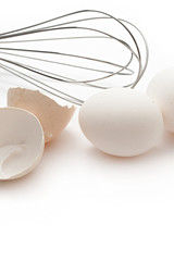 Eggs with whisk isolated on the white background