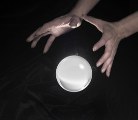 crystal ball and hands around