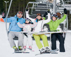 Fototapeta premium Happy skiers on ski lift