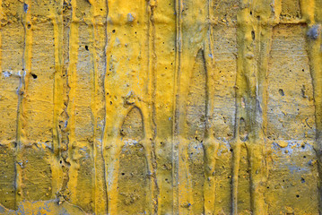 Part of a concrete wall with yellow streaks