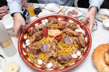 Man holds pilau dish