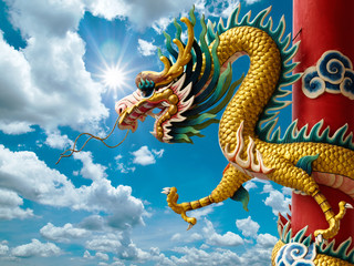 Fototapeta na wymiar Golden Chinese Dragon and bright sky