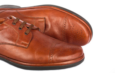 The brown elegant men's shoes on the white isolated background