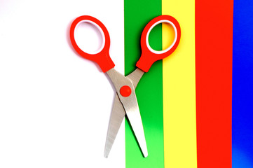 Colorful paper with child's scissors