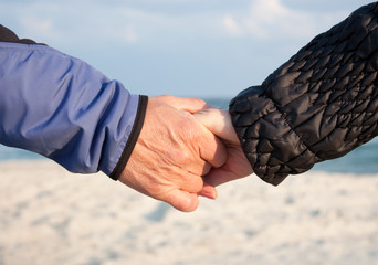 Holding hands on beach
