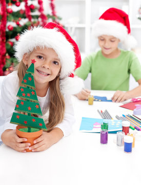 Kids making christmas decorations and postcards