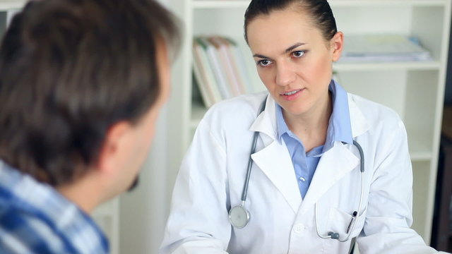 Female doctor talking to male patient